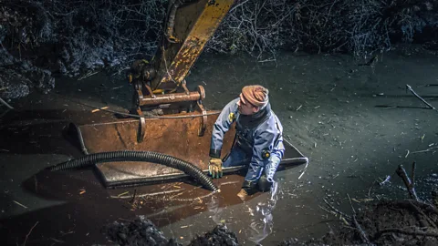 Denis Aldokhin The ground around the tanks has to be drained before they can be lifted out (Credit: Denis Aldokhin)