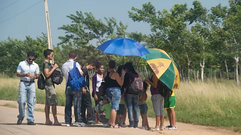 Roberto Machado Noa/Getty Images Like many Cubans, Tom and Ernesto sometimes wait hours for a ride (Credit: Roberto Machado Noa/Getty Images)