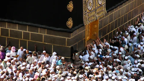 Alamy Muslim pilgrims making the Hajj to Mecca walk around the Kaaba and attempt to kiss part of the Black Stone embedded in its side (Credit: Alamy)