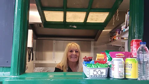 Ella Buchan Jude Holmes also sells snacks to the public through the hatch of the Russell Square shelter (Credit: Ella Buchan)
