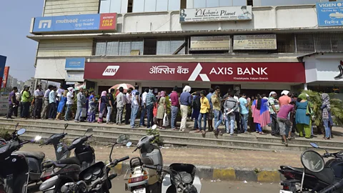 Getty Images Some denominations of Indian bank notes were discontinued in 2016 leading to long queues of people waiting to withdraw money (Credit: Getty Images)