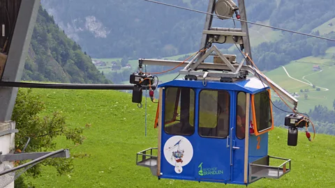Larry Bleiberg Farmer Ueli Schmitter admits to being obsessed with his blue-and-green cable cars, and helps his neighbours keep theirs in good working order (Credit: Larry Bleiberg)