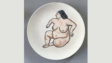 Sue Tilley Tilley describes this image she painted on a plate as The Benefit Supervisor Has Woken Up (Credit: Sue Tilley)