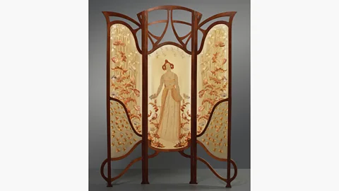 Gemeentemuseum Den Haag A teak and embroidered silk room divider by Dutch designer Carel Wirtz depicts a flower queen, created in 1902 (Credit: Gemeentemuseum Den Haag)
