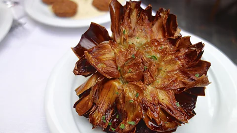 Emma Lapperruque/Alamy <I>Carciofi alla giudia</I>, or Jewish-style artichokes, is the most iconic dish of Roma-Jewish cuisine (Credit: Emma Lapperruque/Alamy)