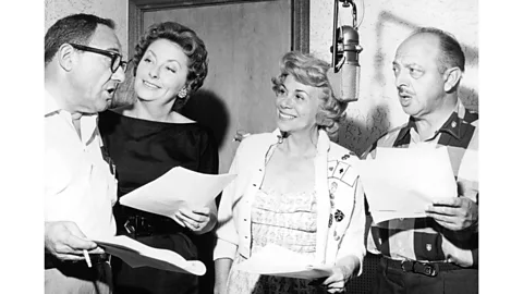 Getty Images The cast of The Flintstones in a recording session in 1962, including Looney Tunes actor Mel Blanc (far right) (Credit: Getty Images)