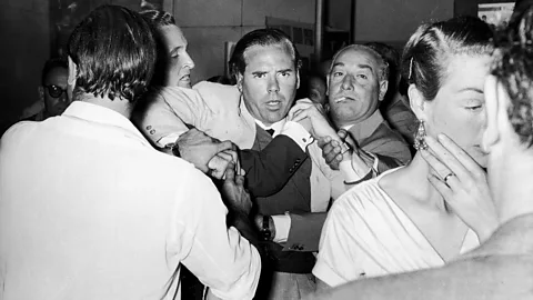 Alamy McClory, seen here in a bar room brawl in 1959, sued Fleming after the author chose other film producers to adapt Bond – but retained elements of his screenplay (Credit: Alamy)