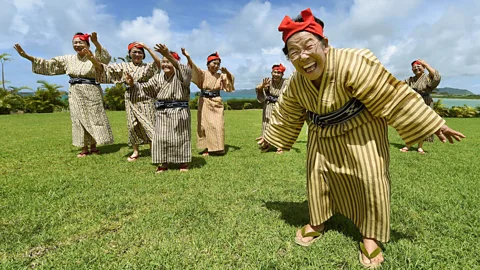 Getty Images These elderly singers from Okinawa are members of Japanese 'girl band' KBG84, with an average age of 84 (Credit: Getty Images)