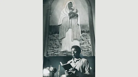 Getty Images A black Madonna is shown behind Beverly Williamson, caretaker of the Central United Church of Christ in Detroit (Credit: Getty Images)