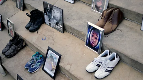 Getty Images Photos and shoes of gun violence victims are exhibited at an anti-gun rally in Philadelphia in 2018 (Credit: Getty Images)