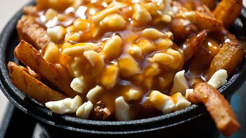 dbimages/Alamy In Québec, the origin of poutine – fries topped with gravy and cheese curd – is nearly as much a source of contention as that of the French fry itself (Credit: dbimages/Alamy)