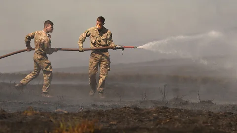 Getty Images One of the most polluting stages of a wildfire, like the one shown here at Saddleworth Moor, is when it is smouldering (Credit: Getty Images)