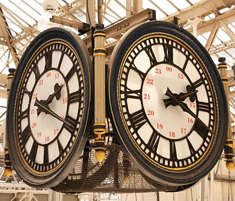 A grand clock showing Roman numerals.