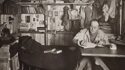 Herbert Ponting/Wikipedia Robert Falcon Scott writing his journal (Credit: Herbert Ponting/Wikipedia)