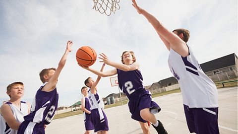 Boys playing basketball outside