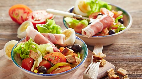 Two bowls of salad on a table