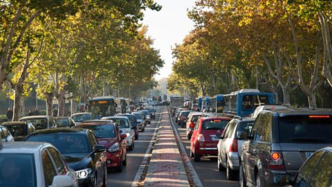 Four lanes traffic jam on treelined road in Madrid