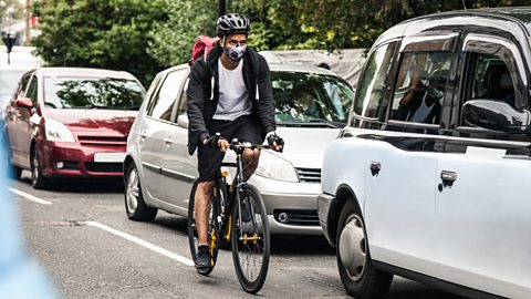 Commuter on bike wearing pollution mask