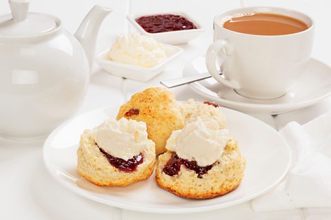 A photo of scones with cream and jam