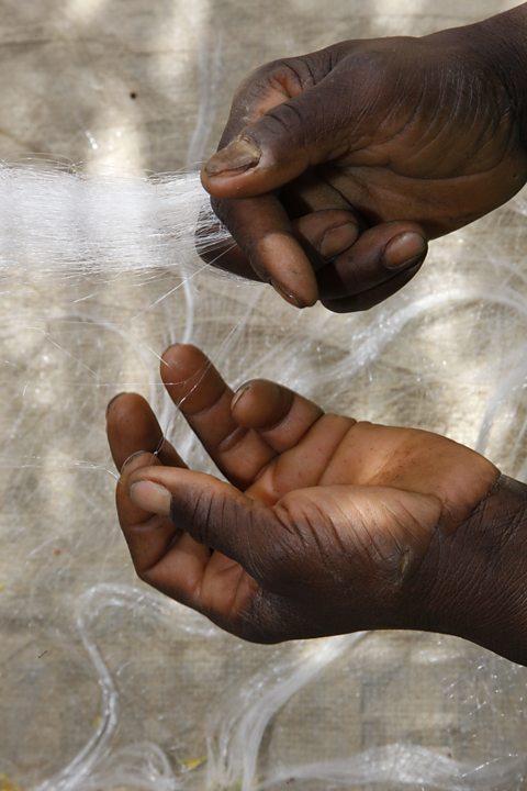 Photo of hands knotting a fishing net on Lagdo Lake