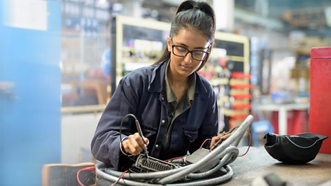 An apprentice electrician in car factory