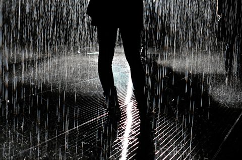 A photo of a woman in silhouette in the rain