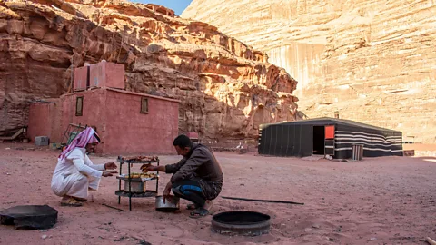 Amanda Ruggeri Back at camp, Abu Rashid and the cook, Muhammed, readied zarb for dinner (Credit: Amanda Ruggeri)