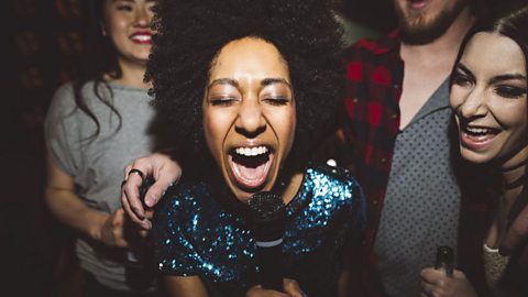 Young woman singing karaoke