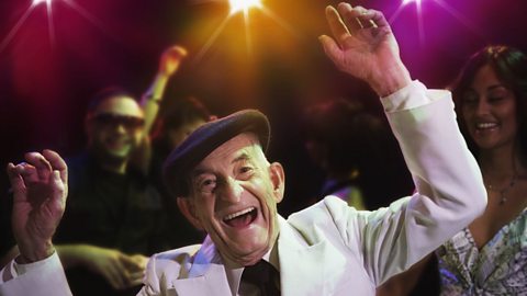 An elderly man dancing in a club