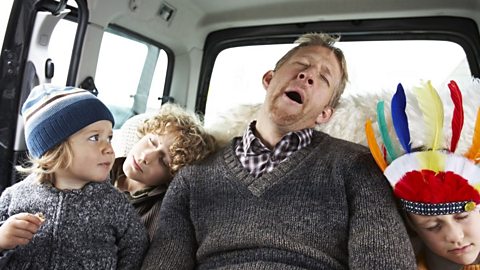 A man snoring in the back of his car with his children