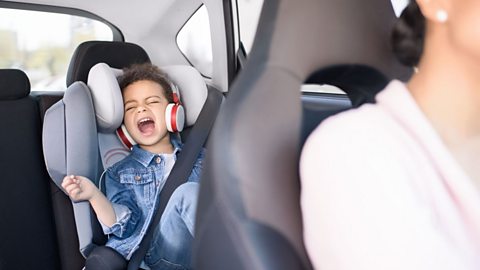 Child singing loudly in the back of a car