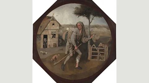 Wikimedia The limping pedlar in Bosch’s The Wayfarer has been seen as choosing between virtue (on the right) or debauchery (on the left) (Credit: Wikimedia)