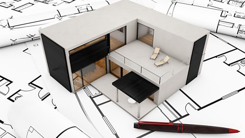 A model building plan design of a stylish home placed on top of drawings of floor plans.