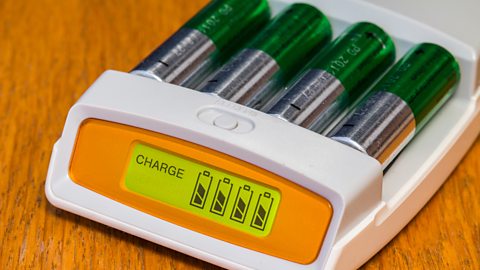 A set of four AA rechargeable batteries on charge.