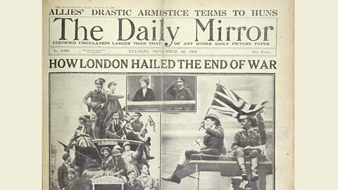 A front page of The Daily Mirror newspaper with a headline that reads ‘How London hailed the end of war.’ There are photos of people waving flags and smiling. 