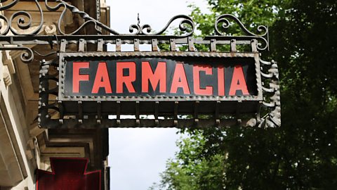 Spanish pharmacy sign on side of building