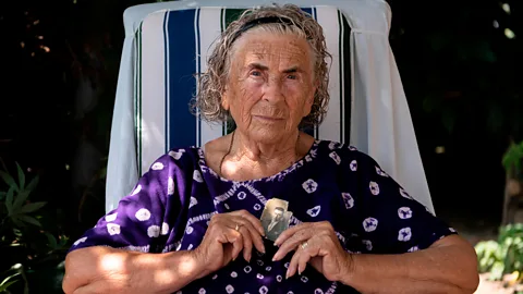 Getty Desamparats Bayona, 88, holds a portrait of her father, Vicente Bayona, one of the many executed who were buried in Franco-era mass graves (Credit: Getty)