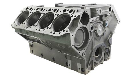 An isolated cylinder block of a truck engine on a white background.