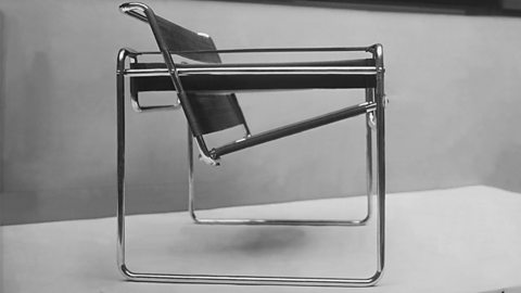 A black and white image of a metal framework chair.