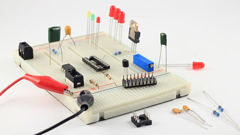 A side view of a prototype of a solderless breadboard with components placed on top.