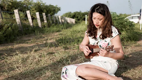 Shao Po Chao Chang performs songs that were played to soldiers in the past, moving from inside the tower to sit on the grass outside (Credit: Shao Po Chao)