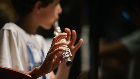 A boy playing a flute