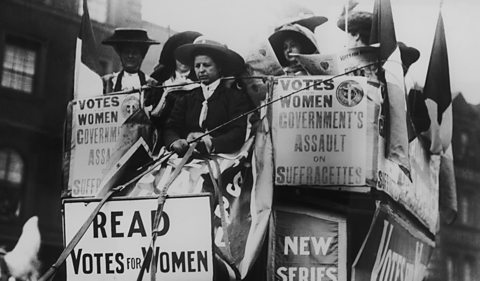 A large carriage full of suffragettes campaigning in London in 1910