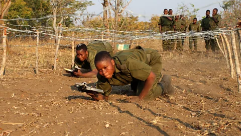 Two of the rangers, Tariro Sikwenya (front) and Wadzanai Munemo, race through an obstacle course during training (Credit: Rachel Nuwer)