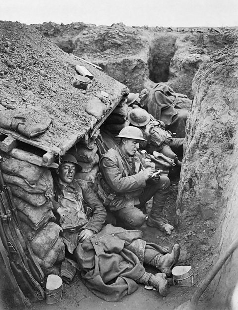 Canadian soldiers sleeping and writing letters in a World War One trench.