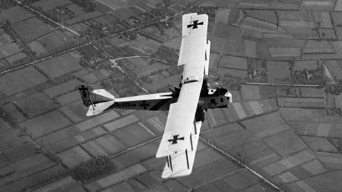 A German Gotha bomber flying over fields during World War One