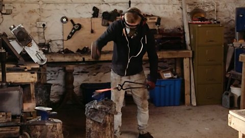 Dan forging a knife on an anvil with his hammer