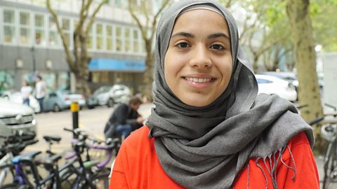 A young woman stands in the street in London