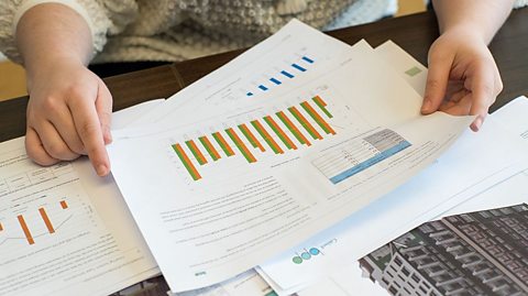 Papers on a desk display graphs