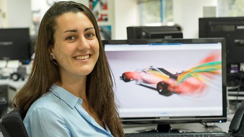 A young woman, Amy, is working on an F1 design at the computer